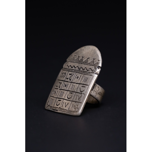 26 - A Tuareg Tribal Berber Silver Talismanic Ring.

The ring is crafted in silver, featuring a large, re... 