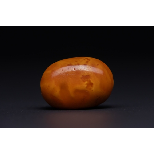 32 - A Butterscotch Amber Barrel Bead with Natural Inclusions.

A single rounded barrel-form amber bead o... 