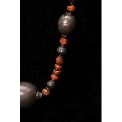 56 - A Turkmen Tribal Silver and Coral Bead Necklace.

The necklace is formed from a strand of irregular ... 