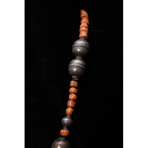 56 - A Turkmen Tribal Silver and Coral Bead Necklace.

The necklace is formed from a strand of irregular ... 