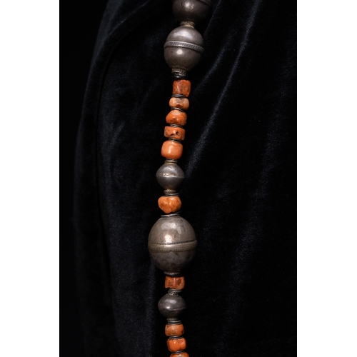 56 - A Turkmen Tribal Silver and Coral Bead Necklace.

The necklace is formed from a strand of irregular ... 