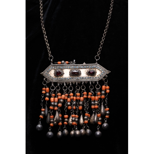 57 - A Bukhara Silver and Coral Necklace, Early 19th Century.

The necklace is composed of a linked silve... 