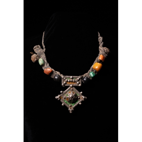58 - A Berber Silver, Coral, Amazonite, Carnelian and Amber Necklace, 19th Century.

The necklace is form... 