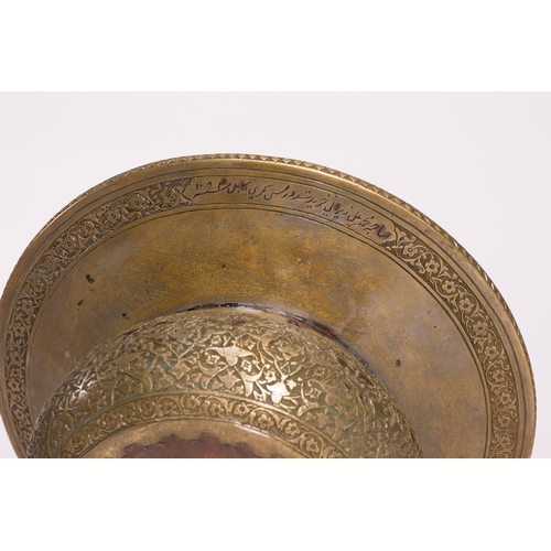 41 - A Persian Brass Ewer and Basin Set with Engraved Decoration.

The set comprises a ewer of bulbous fo... 