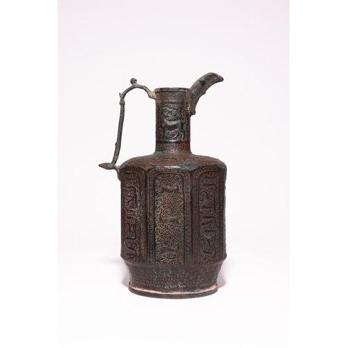 44 - An Islamic Bronze Faceted Ewer with Zoomorphic Panels, 12th Century.

A bronze ewer of faceted balus... 