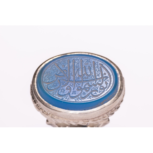 46 - An Islamic Silver Ring Set with a Carved Blue Agate Panel Featuring Arabic Calligraphy.

An Islamic ... 