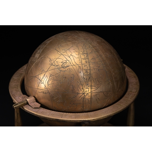 55 - An Islamic Brass Celestial Globe on Stand with Engraved Zodiac and Script.

An Islamic brass celesti... 