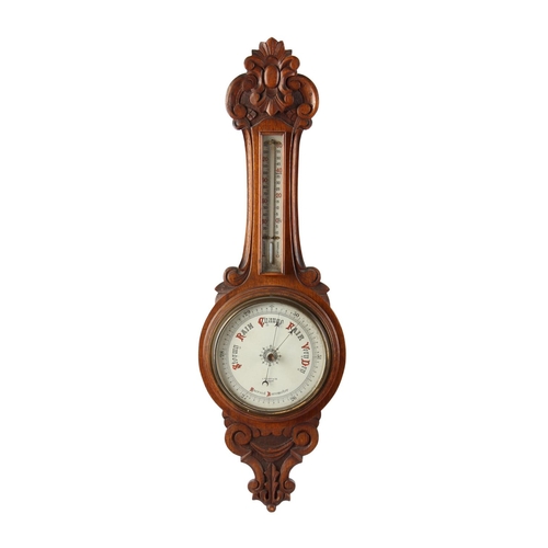 109 - Property of a lady - a late Victorian carved oak cased aneroid barometer & thermometer, 33.25ins. (8... 