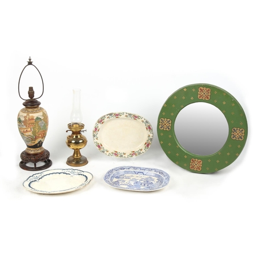 111 - A green painted circular framed wall mirror; together with two table lamps; and three meat-plates (6... 