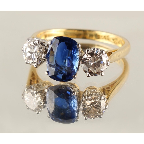 171 - An 18ct yellow gold sapphire & diamond three stone ring, the central cushion cut sapphire weighing a... 