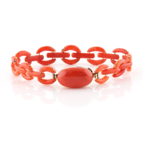 181 - A coral link bracelet, the clasp tongue with French 9ct gold cloverleaf mark, 6.9ins. (17.5cms.) lon... 