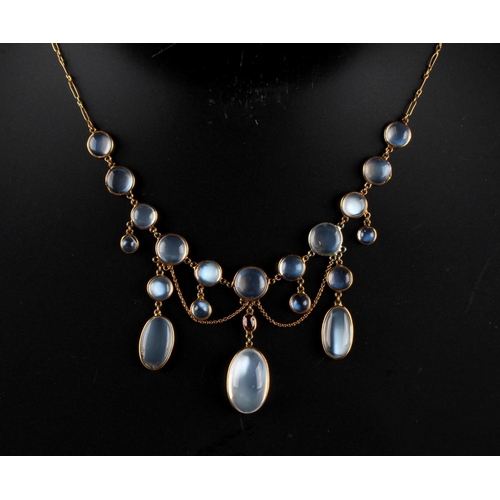 208 - An unmarked yellow gold moonstone & ruby festoon necklace, 16ins. (40.5cms.) long (see illustration)... 