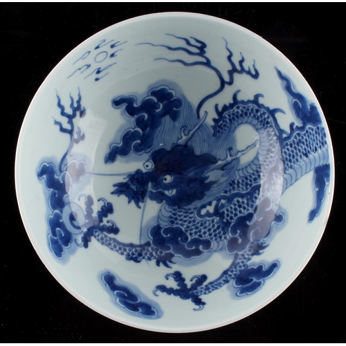 265 - A Chinese blue & white dragon bowl, painted with a single 5-clawed dragon emanating from the exterio... 