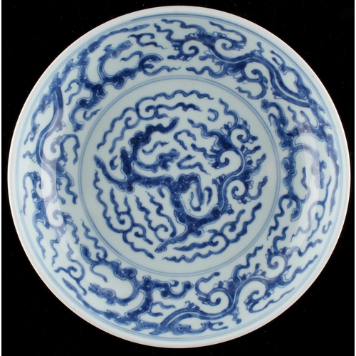 266 - A Chinese blue & white dragon dish, the base un-glazed, 8.1ins. (20.5cms.) diameter (see illustratio... 