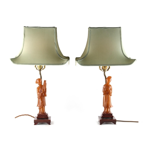 297 - Property of a lady - a pair of Chinese carved amber figures of ladies, mounted as table lamps, the a... 