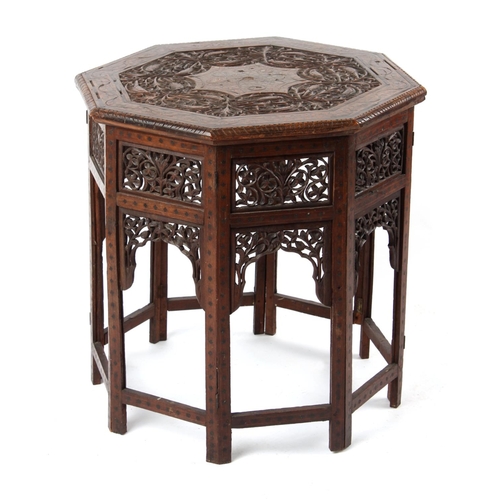 44 - Property of a gentleman - an Indian carved teak & brass inlaid octagonal folding table, 23ins. (58.5... 