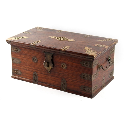 45 - An Indian hardwood box with pierced brass mounts, 17ins. (43cms.) wide (see illustration).