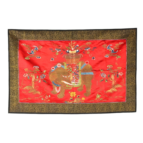 472 - A late 19th / early 20th century Chinese embroidered scarlet silk panel depicting a caparisoned elep... 