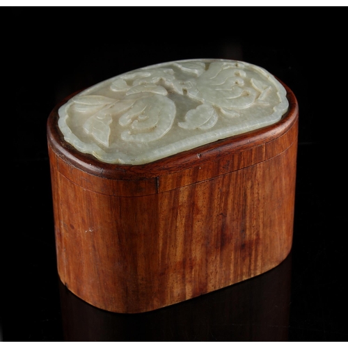 474 - A 19th century Chinese hongmu oval box, the cover inset with a pale celadon jade panel carved in rel... 