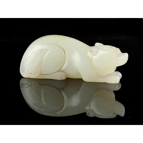 475 - A Chinese carved very pale celadon model of a recumbent bear, 2.8ins. (7.1cms.) long (see illustrati... 