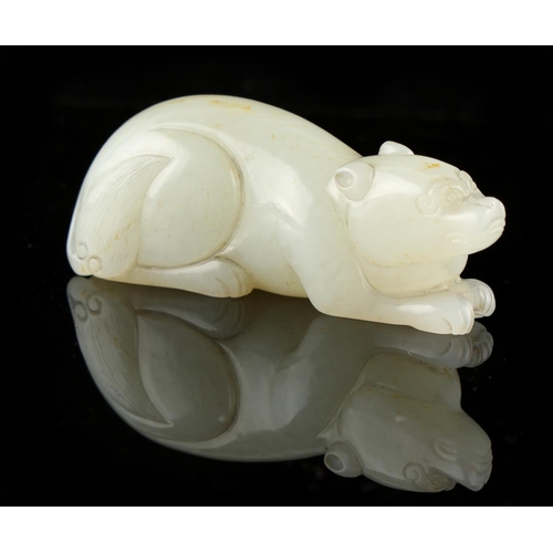 475 - A Chinese carved very pale celadon model of a recumbent bear, 2.8ins. (7.1cms.) long (see illustrati... 