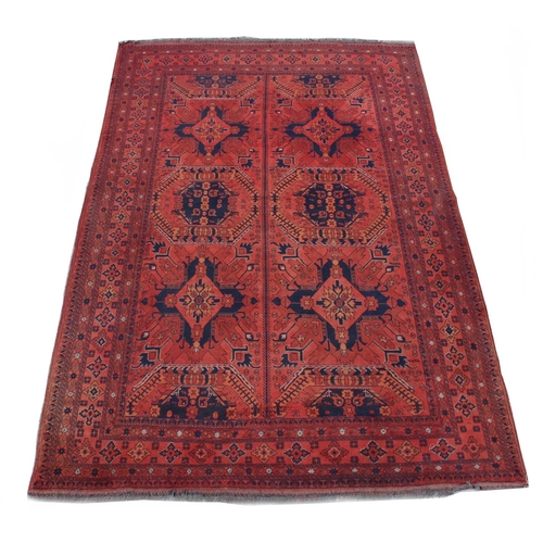 50 - Property of a lady - a mid 20th century Turkoman carpet with red ground, 116 by 79ins. (295 by 201cm... 