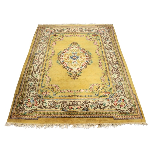 51 - Property of a gentleman - an Indian hand knotted wool carpet with pale yellow ground, 143 by 108ins.... 