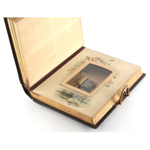 5 - Property of a gentleman - a late Victorian leather photograph album incorporating a cylinder musical... 