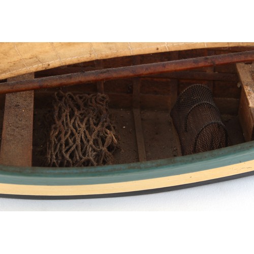 274 - Property of a gentleman - painted wood model fishing boat, complete with two oars, a folded net, a l... 