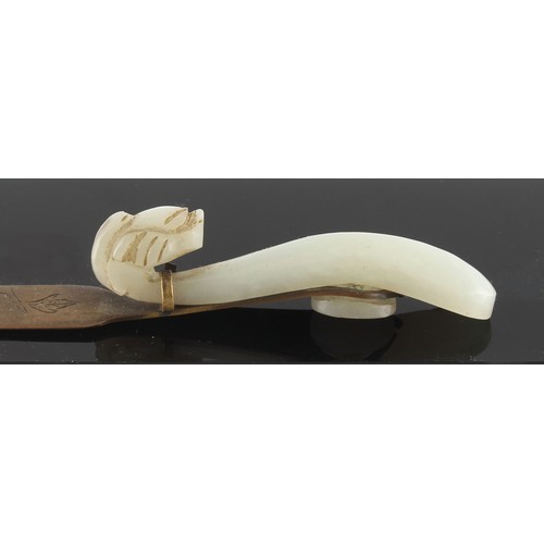 189 - Property of a gentleman - a Chinese carved pale celadon jade gui belt hook, late Qing Dynasty, adapt... 