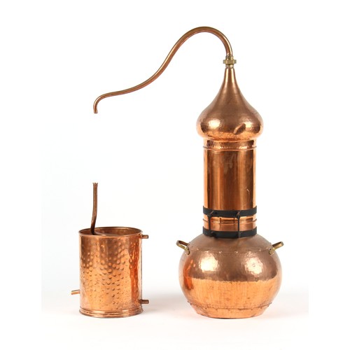 444 - A copper alembic perfume still, 42.5ins. (108cms.) high.   Provenance - L'Occitane, Salisbury.