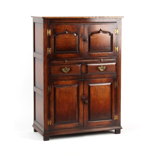 511 - Property of a gentleman - a good quality reproduction oak court cupboard with an arrangement of pane... 