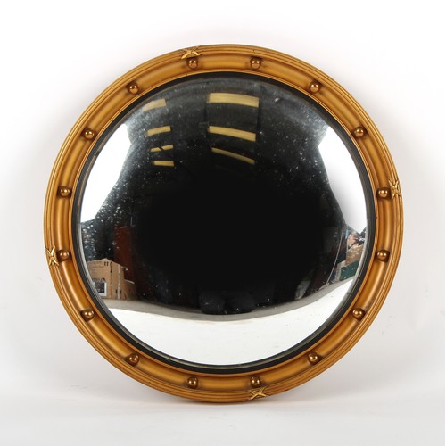 401 - Property of a gentleman - a gilt circular framed convex mirror, first half 20th century, 21.5ins. (5... 