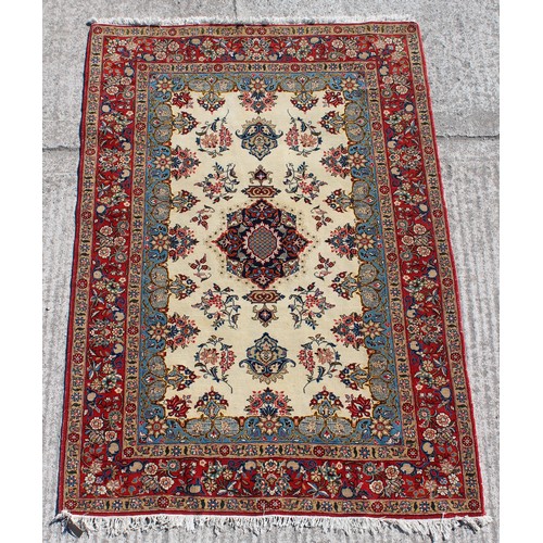 382A - Property of a gentleman - a finely woven Kashan rug with ivory field, 80 by 56ins. (203 by 143cms.).