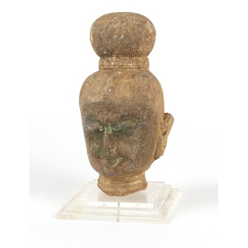 125 - Property of a gentleman - an antique carved stone Buddha head, South East Asia, mounted on a perspex... 