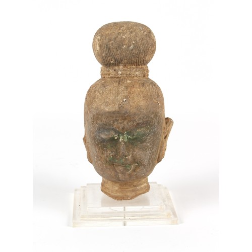 125 - Property of a gentleman - an antique carved stone Buddha head, South East Asia, mounted on a perspex... 