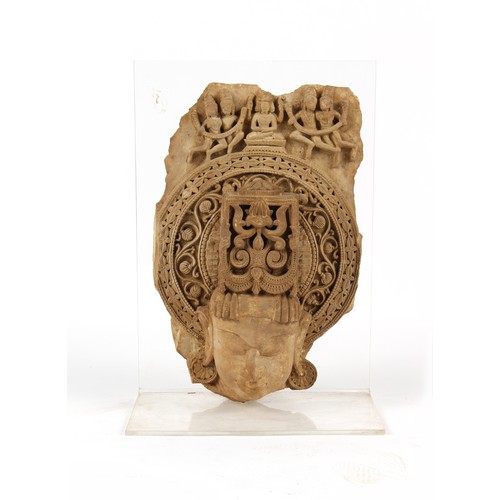 209 - Property of a gentleman - an Indian carved sandstone fragment, on perspex stand, 26.5ins. (67.5cms.)... 