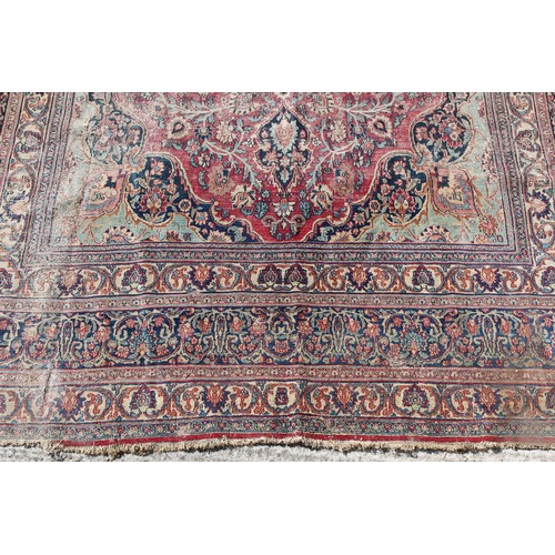 367A - Property of a gentleman - an antique Kirman carpet, worn, 168 by 112ins. (427 by 285cms.).