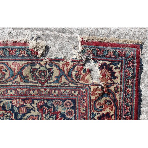 367A - Property of a gentleman - an antique Kirman carpet, worn, 168 by 112ins. (427 by 285cms.).