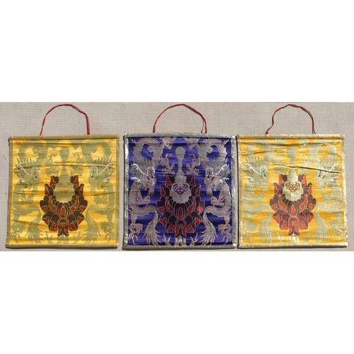 100 - A set of three Tibetan embroidered silk & metal thread wall hangings, each 26.8 by 25.4ins. (68 by 6... 