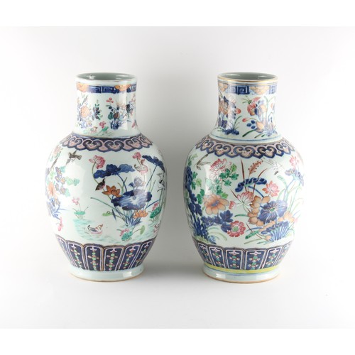 79 - Two very similar late 19th century Chinese famille rose vases, painted with birds among flowering sh... 