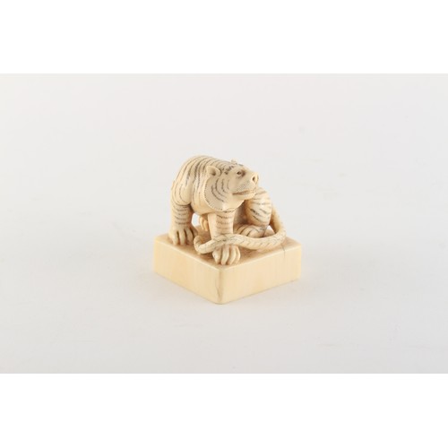 169 - Property of a gentleman - a Chinese carved ivory square seal modelled as a seated tiger, early 20th ... 