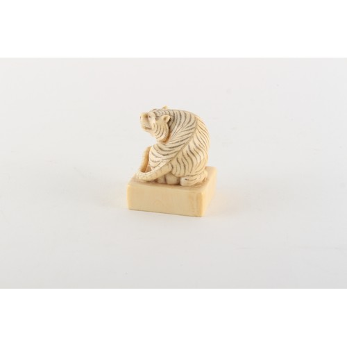 169 - Property of a gentleman - a Chinese carved ivory square seal modelled as a seated tiger, early 20th ... 