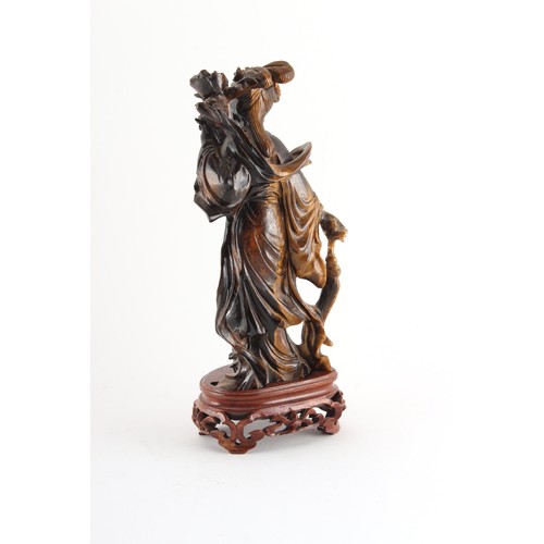 184 - Property of a deceased estate - a Chinese carved tiger's eye figure of Guanyin, on fitted wooden sta... 