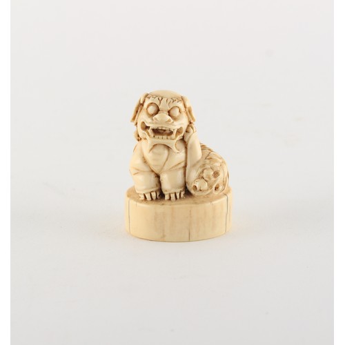 170 - Property of a gentleman - a Chinese carved ivory chop seal modelled as a seated Buddhistic lion, lat... 