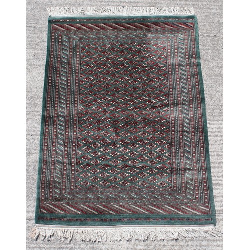 360 - Property of a gentleman - a good quality Tekke design hand knotted rug with green ground, 71 by 49in... 