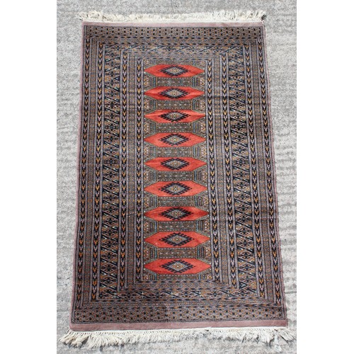 362 - Property of a gentleman - a Tekke design hand knotted rug with red ground, 57 by 35ins. (146 by 89cm... 