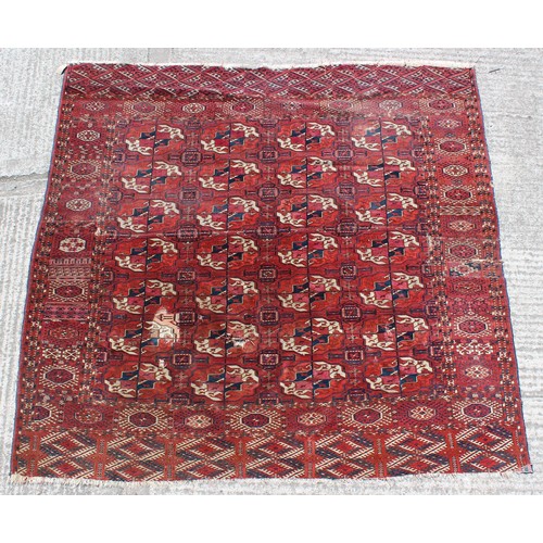 370A - Property of a gentleman - a Turkoman carpet, damages, 87ins. (227cms.) square.