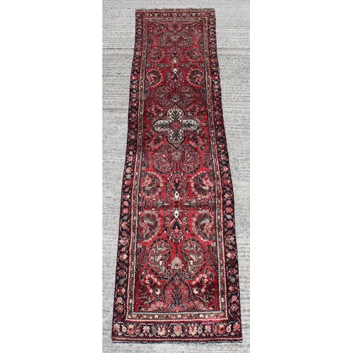 375 - A Hamadan woollen hand-made runner with red ground, 150 by 37ins. (380 by 94cms.).