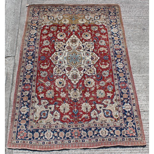 378 - Property of a gentleman - a Persian Tabriz small carpet with red ground, pronounced abrash to one en... 